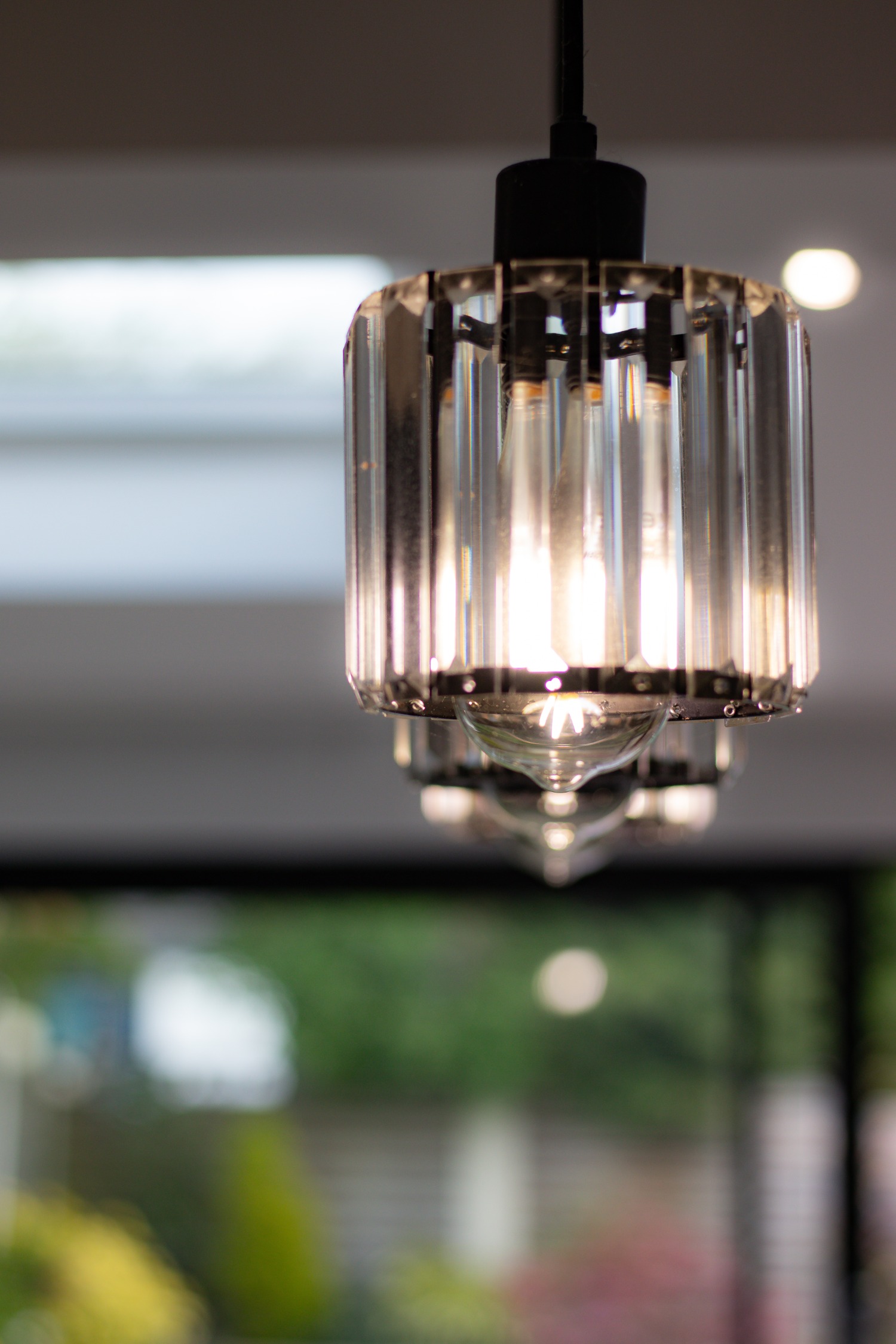Glass lighting hanging from roof with a sky light
